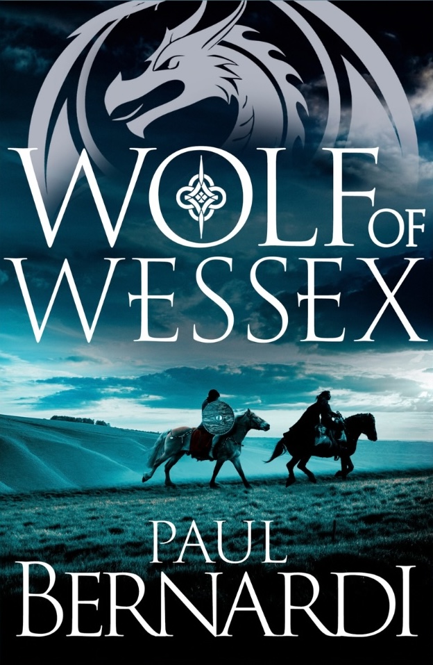 The book cover for Wolf of Wessex by Paul Bernardi. Two riders cross a misty hillside beneath a stormy sky, with a dragon emblem above the title.